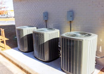 An outdoor air conditioning units has been installed on exterior facade of a new busines